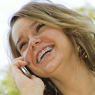 stock photo of a girl with braces on the phone